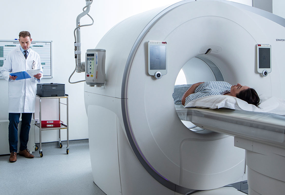 Patient im CT-Scanner Ärztin im Weißen Kittel Hält Blaues Klemmbrett in der Hand und Steht Neben Dem Brother HL-L2370DW-DRUCKER